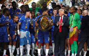 Chelsea (ENG) celebrates their championship as the FIFA Club World Cup 2025 champions by beating Paris Saint-Germain (FRA) 3-0 after an intense final at the MetLife Stadium in New Jersey, USA, on July 13, 2025, alongside US President Donald Trump and FIFA President Gianni Infantino (Photo by Deccio Serrano/NurPhoto). (Photo by DECCIO SERRANO / NurPhoto via AFP)