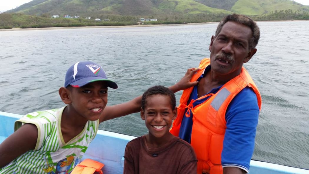 Laite Ravato's husband, Emosi, with grandson Sela and nephew Joe after Cyclone Winston.
