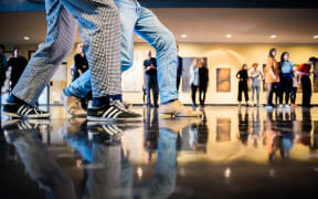 05 November 2022, Berlin: A couple dances at a free swing or Lindy Hop dance class to warm up in the foyer of the Deutsche Oper. The Berlin State Ballet and the Deutsche Oper offer free dance classes on Saturdays in November to brave the dropping temperatures with tango, swing and salsa. Photo: Christoph Soeder/dpa (Photo by Christoph Soeder / DPA / dpa Picture-Alliance via AFP)