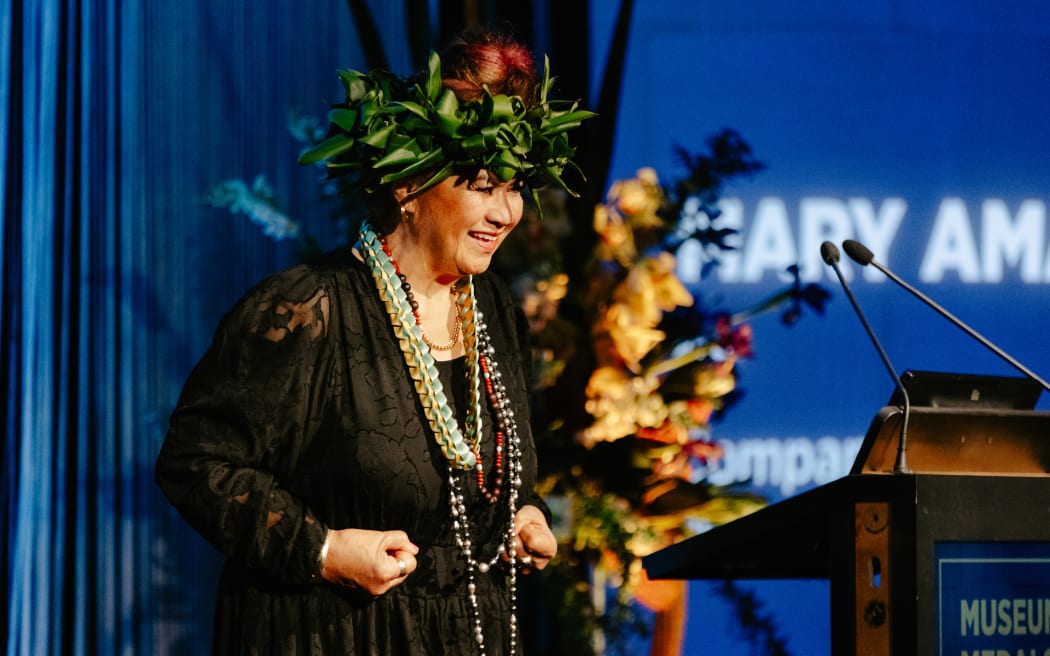 Cook Islander Mary Ama receives her Museum Medal on stage.