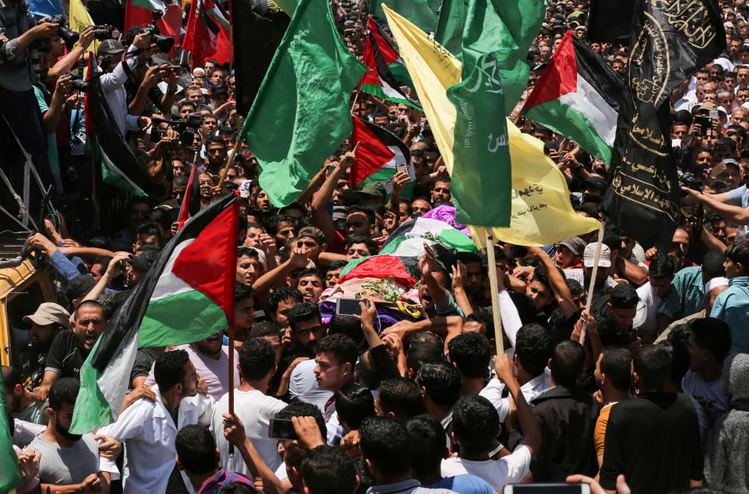 Palestinian mourners carry the body of 21 years old Razan al-Najjar during her funeral after she was shot dead by Israeli soldiers, in Khan Yunis on June 2, 2018.
