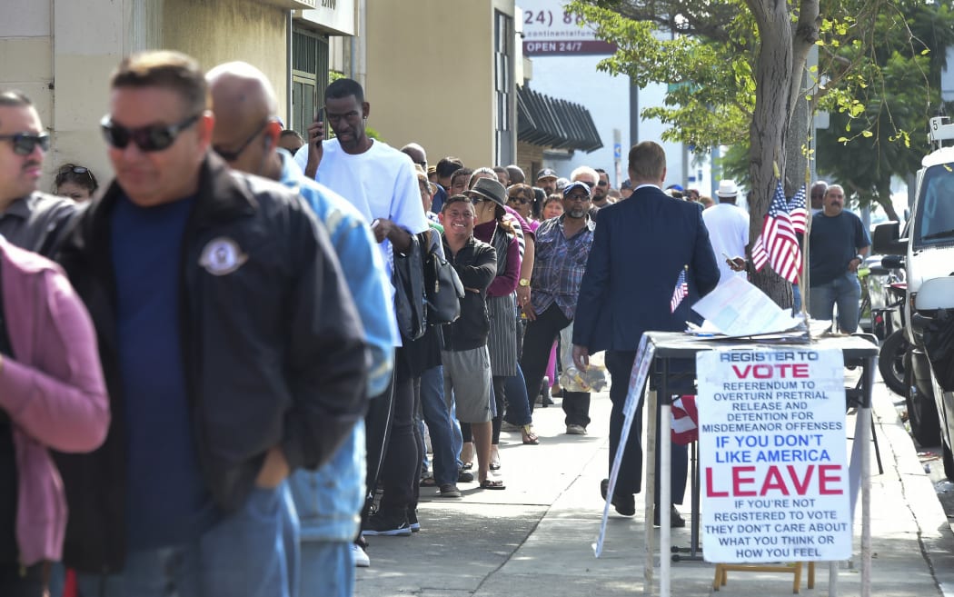 People wait in a long line to purchase lottery tickets outside the Blue Bird Liquor store in Hawthorne, California.