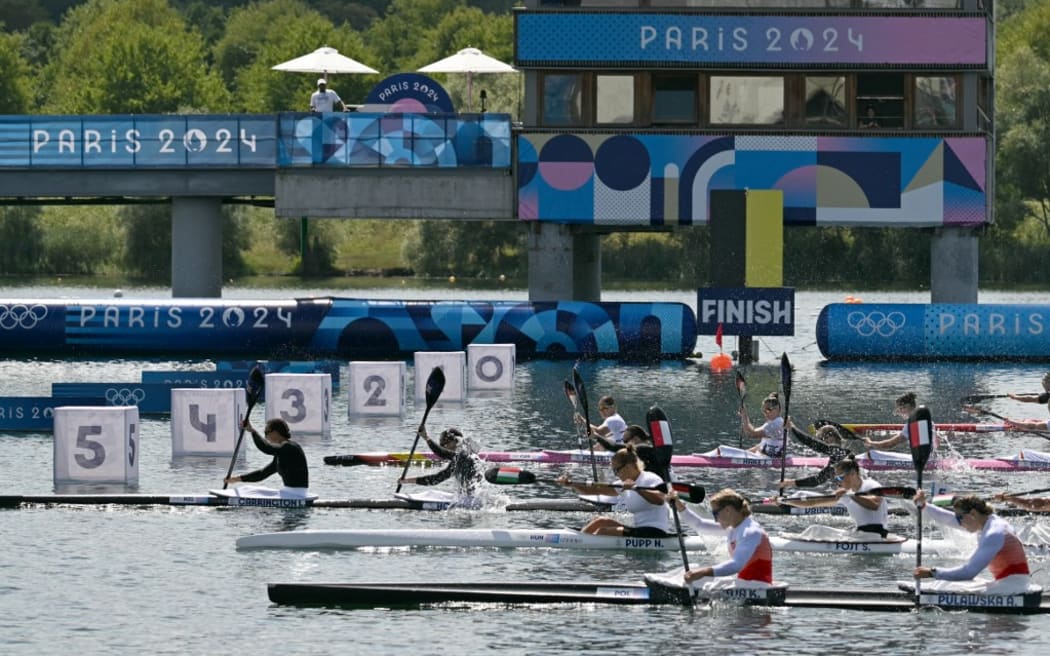 (From L) New Zealand's Lisa Carrington, Alicia Hoskin, Olivia Brett and Tara Vaughan cross the finish in first place followed by Germany and Hungary's boats in the women's kayak four 500m final of the canoe sprint competition at Vaires-sur-Marne Nautical Stadium in Vaires-sur-Marne during the Paris 2024 Olympic Games on August 8, 2024. (Photo by Bertrand GUAY / AFP)