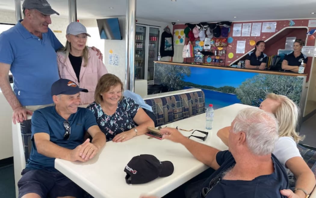 Leigh Fischl (top left, in pink) travelled from Sydney to go whale watching.