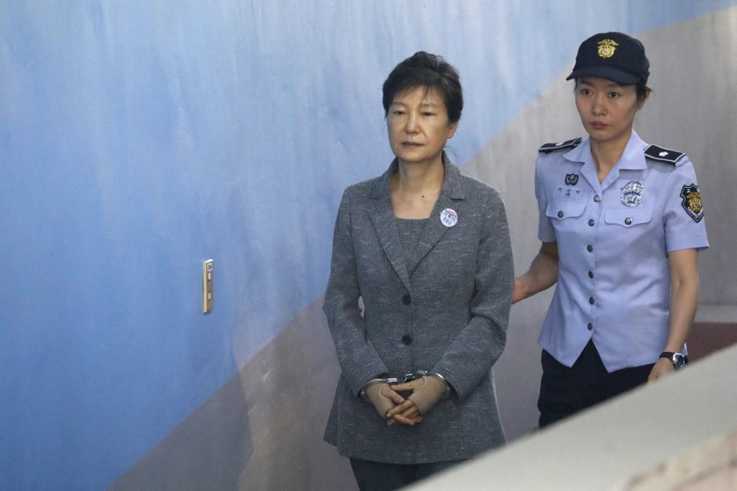(FILES) In this file photo taken on August 25, 2017, South Korean ousted leader Park Geun-hye (L) arrives at a court in Seoul.