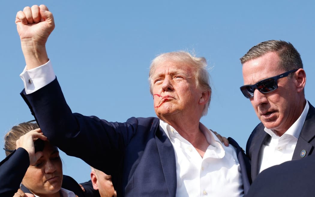 BUTLER, PENNSYLVANIA - JULY 13: Republican presidential candidate former President Donald Trump is rushed offstage during a rally on July 13, 2024 in Butler, Pennsylvania.   Anna Moneymaker/Getty Images/AFP (Photo by Anna Moneymaker / GETTY IMAGES NORTH AMERICA / Getty Images via AFP)