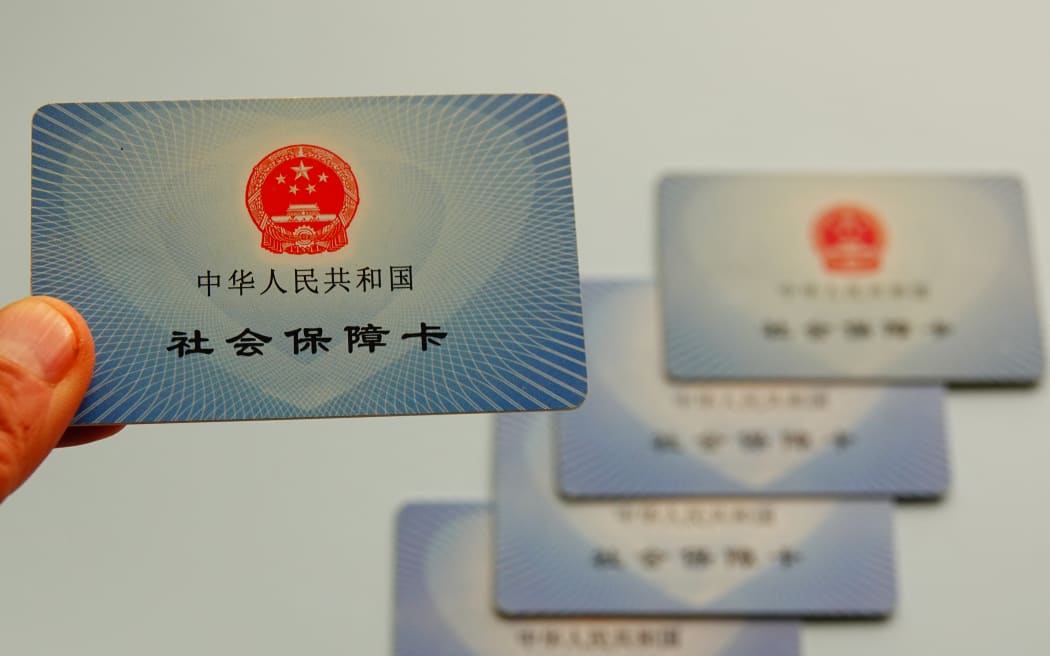 Social security cards are being displayed in Yichang, Hubei Province, China, on March 1, 2024. As of the end of January 2024, the number of social security card holders in China has reached 1.38 billion, covering 97.9 percent of the population. (Photo by Costfoto/NurPhoto) (Photo by CFOTO / NurPhoto / NurPhoto via AFP)