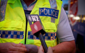 Adriana Weber interviewing an officer about drink driving.