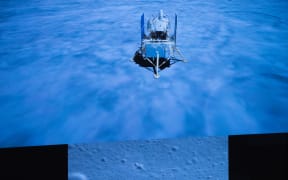 Photo taken at Beijing Aerospace Control Center (BACC) in Beijing on 1 December 2020 shows the Chang'e-5 spacecraft landing on the moon.