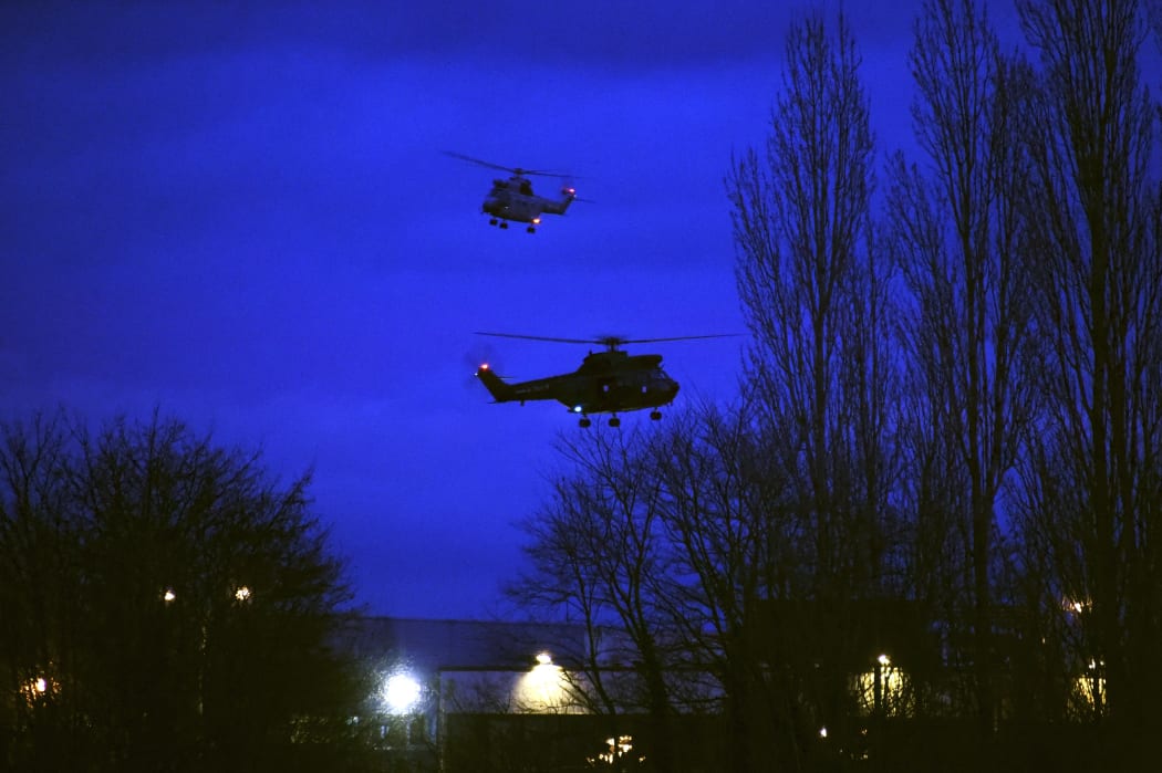 Helicopters fly over buildings in Dammartin-en-Goele, north-east of Paris, after the standoff between the two suspects and special forces.