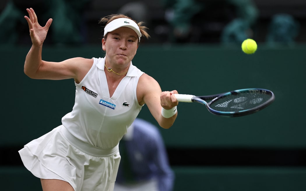 New Zealand's Lulu Sun returns against Britain's Emma Raducanu during their women's singles fourth round tennis match on the seventh day of the 2024 Wimbledon Championships at The All England Lawn Tennis and Croquet Club in Wimbledon, southwest London, on July 7, 2024.