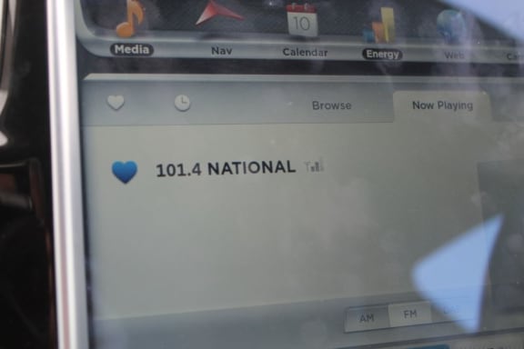 This is  an image of the  radio station read out on the Tesla dashboard , showing Radio New Zealand National.