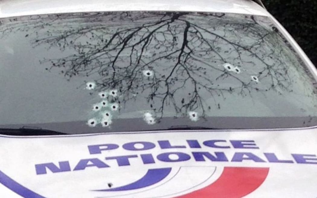 A Paris police car riddled with bullets following the attack.