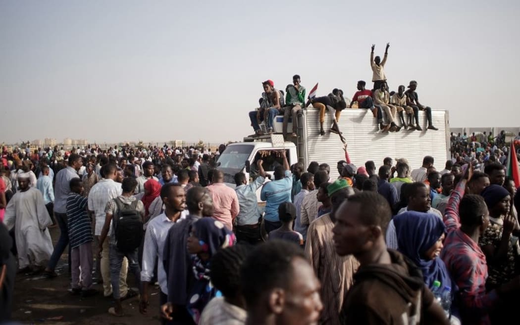 11 April 2019, Sudan, Khartoum: Sudanese demonstrators celebrate the arrest of long-time President Omar al-Bashir by the armed forces,