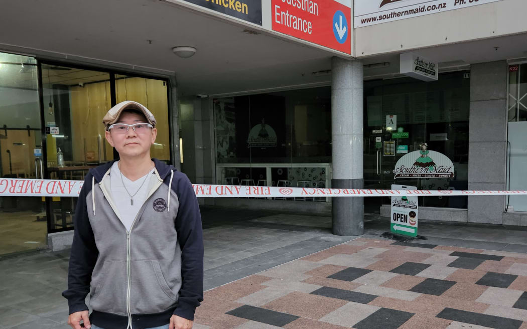 Masanori Nakayama owns a donut shop on the apartment building's ground floor. Its glass door buckled after a beam was damaed in the fire and he is uncertain about the future of his shop.
