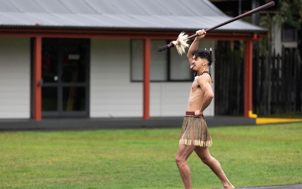 Graduate Kingi Aupouri does the wero with the taiaha he carved and tempered.