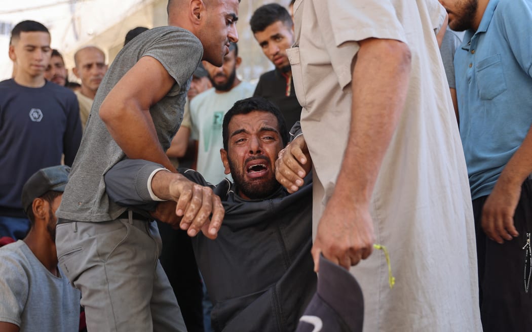 A Palestinian mourner breaks in tears during the funeral procession of people reportedly killed while waiting for aid delivery, in Gaza City, on 3 July, 2025.