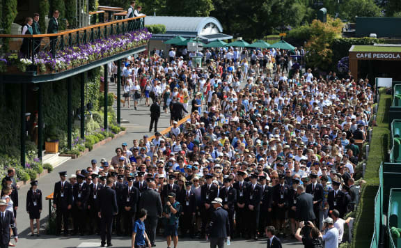 Stewards escort the crowd of spectators into the grounds