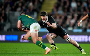 Scott Barrett makes a tackle on Handre Pollard.