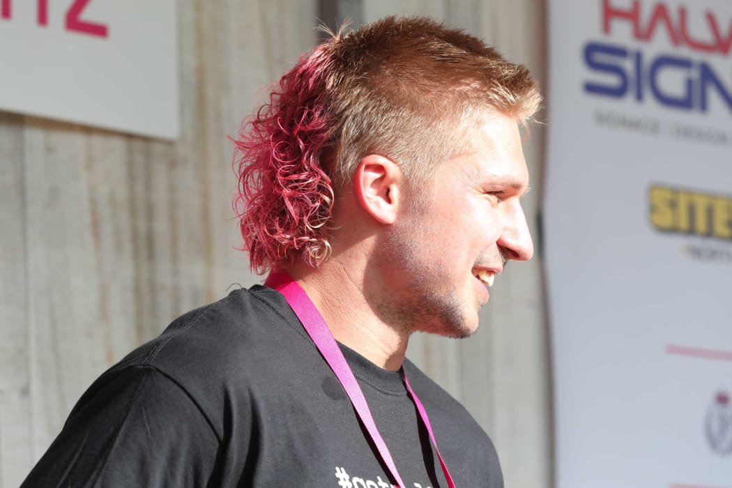 All Black Jack Goodhue got to keep his mullet but made over with pink dye and a perm.