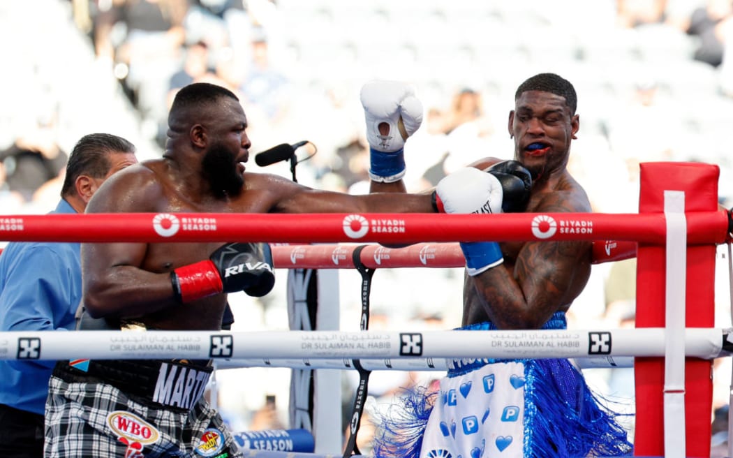 Martin Bakole (L) lands a left to the head of Jared Anderson during the fifth round of their NABF WBO International Heavyweight title fight.