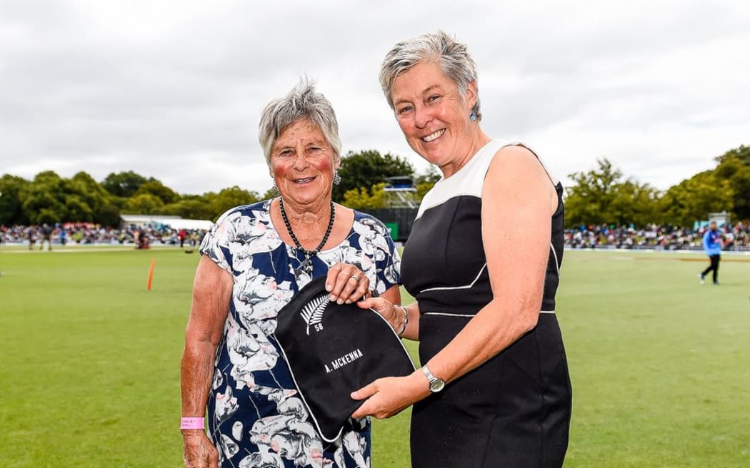 Ann McKenna (left) was White Fern No.58, a double international in cricket and hockey, an A grade squash player and an accomplished golfer. Here she is receiving a cap from NZ Cricket president and former teammate Debbie Hockley in 2019.