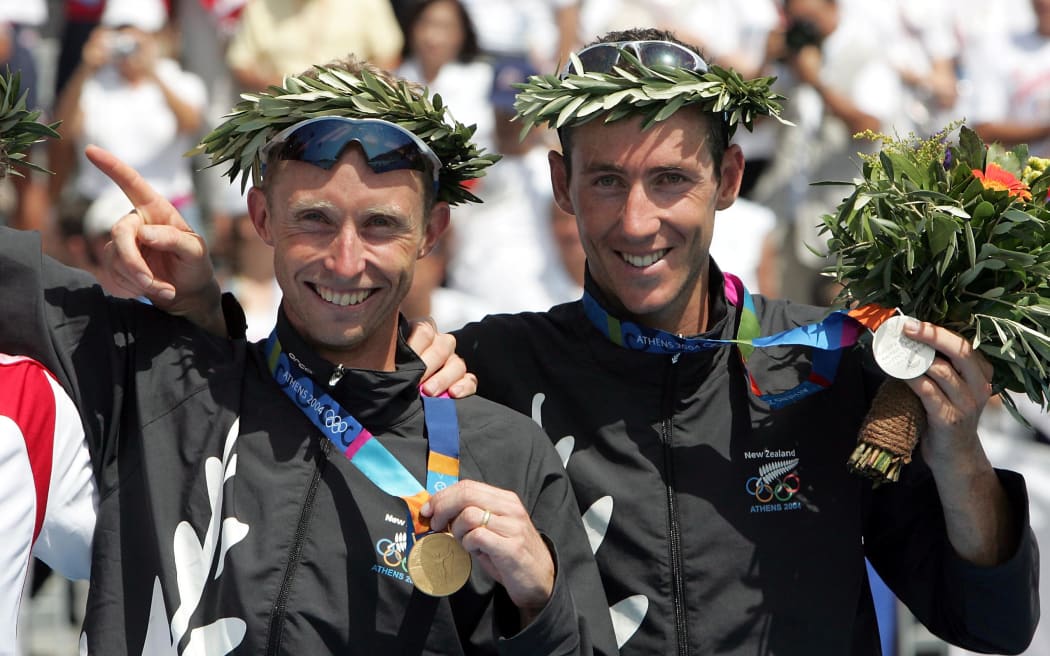 New Zealand's Olympic Triathlon Gold Medalist Hamish Carter shows off his gold medal with Team mate Bevan Docherty who won silver. Athens, Greece, Thursday 26 August 2004
PHOTO: Andrew Cornaga/PHOTOSPORT