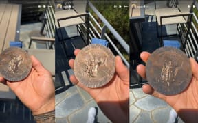 American skateboarder Nyjah Huston displays a Paris Olympics 2024 medal which appears to have deteriorated