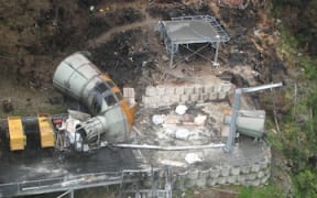 The cap on the ventilation shaft is weighed down with sandbags and cement.