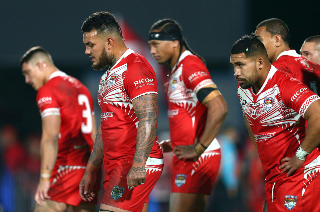 Tongan players stand dejected during Saturday's heavy defeat by the Kiwis.