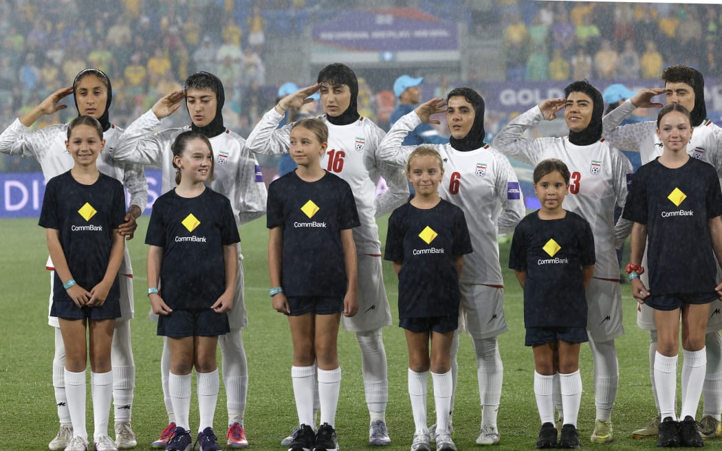 Iran's players salute during the national anthem before the AFC Women's Asian Cup match against Australia.