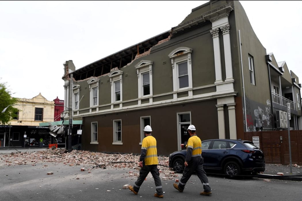 Emergency and rescue officials examine damaged buildings in the popular shopping Chapel Street in Melbourne on September 22, 2021, after a 5.8-magnitude earthquake.