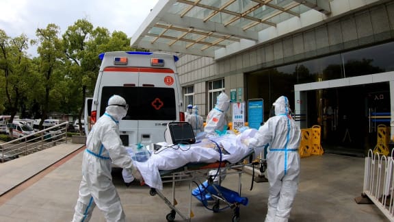 A video screenshot shows medical staff transferring a COVID-19 patient to Zhongnan Hospital of Wuhan University for further treatment in Wuhan, central China's Hubei Province, on April 14, 2020.