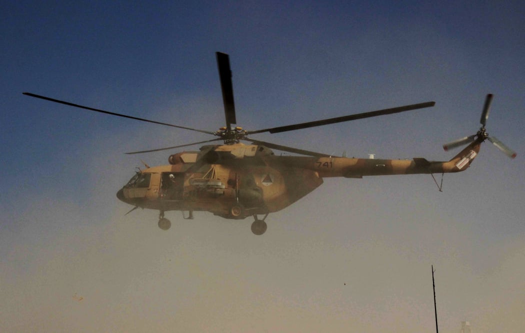 An Afghan helicopter carrying security personnel arrives at the scene of an offensive against Taliban insurgents in Kunduz on 30 September.
