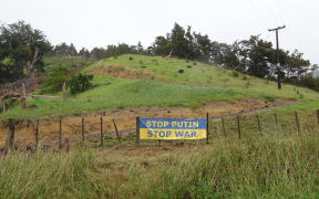 Ukraine flag protest message outside a Helena Bay property.