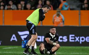 TJ Perenara of New Zealand goes down injured.