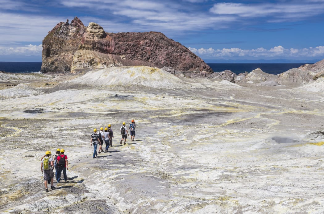 Tourists exploring White Island Volcano, an active volcano in the Bay of Plenty, North Island, New Zealand, Pacific