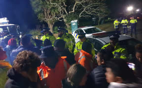 The police line at Ihumatao on Monday evening after more officers were brought in.