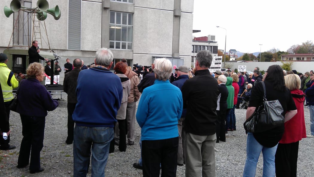 Protest organiser Peter Lynch addresses the crowd gathered next door to the Christchurch City Council building.