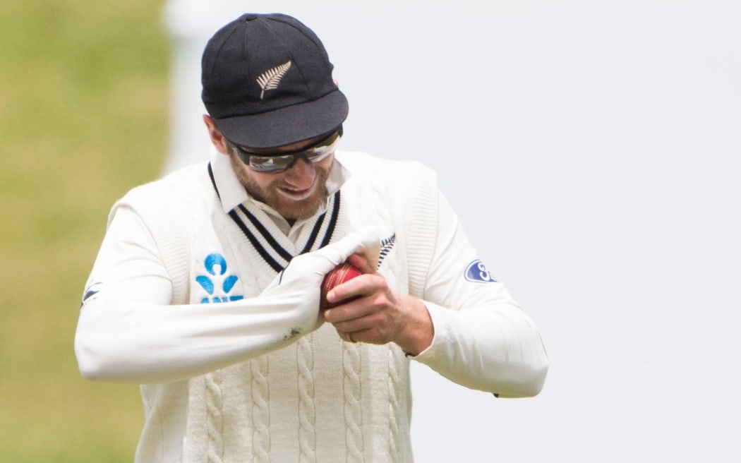 New Zealand's captain Kane Williamson shines the ball.