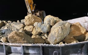 One of the barges with the limestone used for the construction of the reefs.