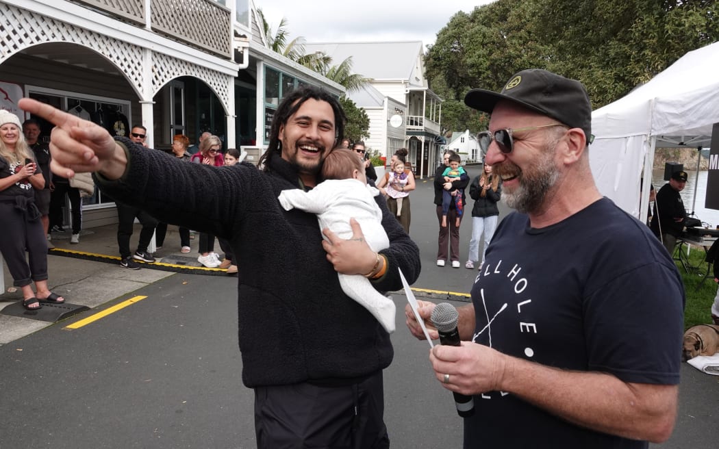 Kree Smith celebrates his win with baby Syden Mager-Smith, 12 weeks, and judge Kent Thwaites.