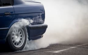 Smoke from under the wheels of the car