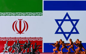 EDMONTON, CANADA - APRIL 15:
Illustrative photo of small figures of soldiers representing two armies in front of the flags of Iran and Israel displayed on a computer screen, on April 15, 2024, in Edmonton, Alberta, Canada. (Photo by Artur Widak/NurPhoto) (Photo by Artur Widak / NurPhoto / NurPhoto via AFP)