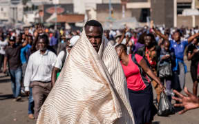 Supporters of Zimbabwe's opposition Movement for Democratic Change (MDC) protest outside the Zimbabwe African National Union Patriotic Front (ZANU-PF) party headquarters in Harare, on August 1, 2018, after protests erupted over alleged fraud in the country's election.