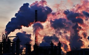 36632031 - chimneys and dark smoke over chemical factory at sunset