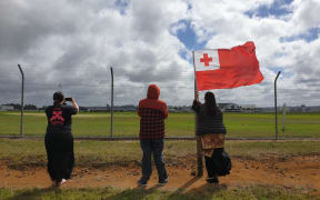 About 10 people gathered outside the base to watch as the plane took off.