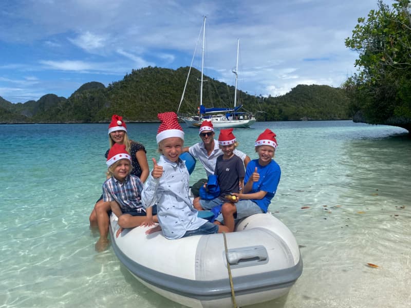 Carolyn and Richard Powles (at the back) with their children: Jackson, Tasman, McKinley and Hawken, all wearing Christmas Santa hats.