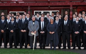 The New Zealand All Blacks pose for a photo with Maori King Tuheitia and his wife Te Atawhai as the All Blacks are welcomed onto the Turangawaewae Marae in Ngaruawahia, in their preparation for their next 2011 Rugby World Cup match, on September 11, 2011.  AFP PHOTO / WILLIAM WEST (Photo by WILLIAM WEST / AFP)