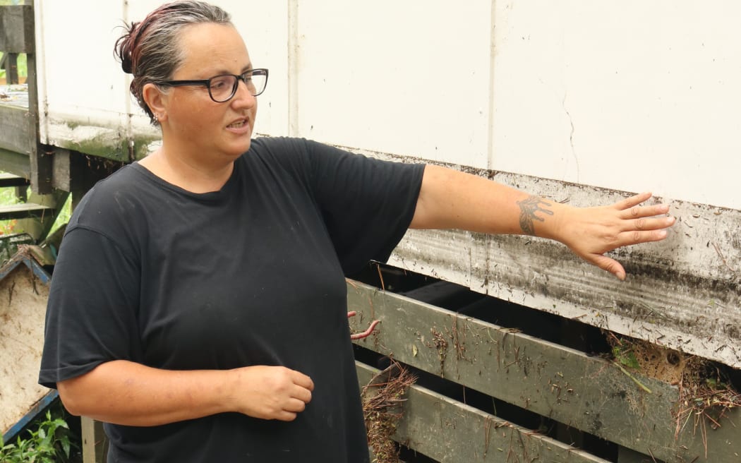 Kimberlee Whitehead shows the level of the February 2018 flood.
